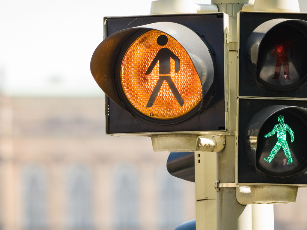 A traffic light that has a walk signal.